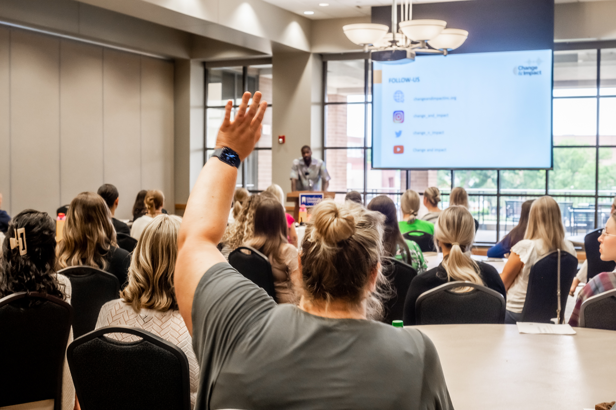 Person raising hand during event