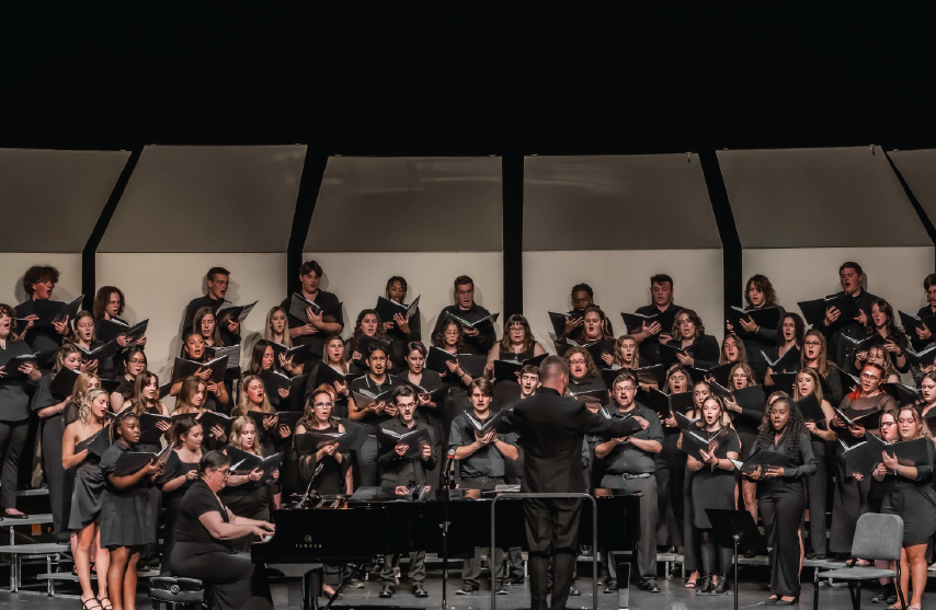 A Large choir on stage performing