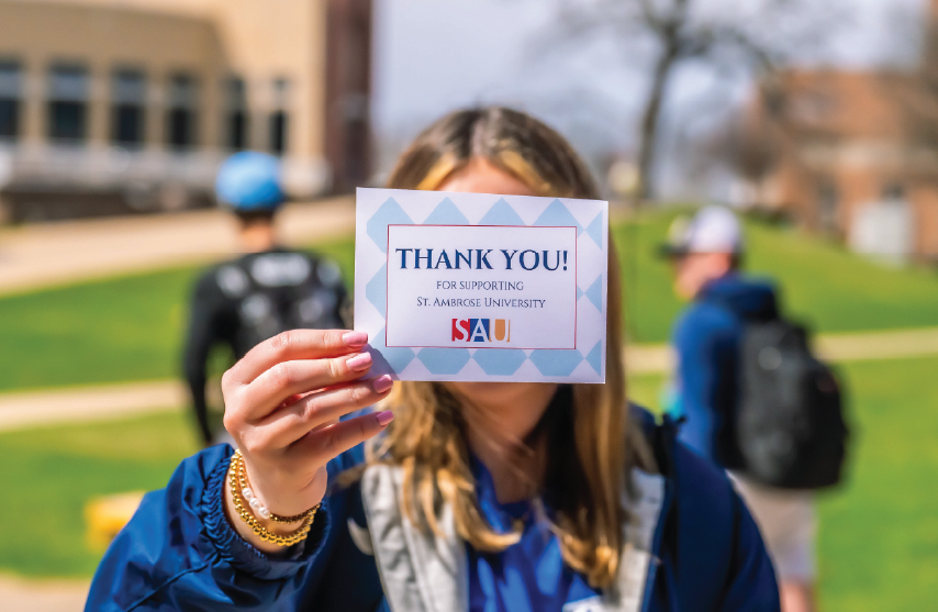 SAU Student holding thank you card