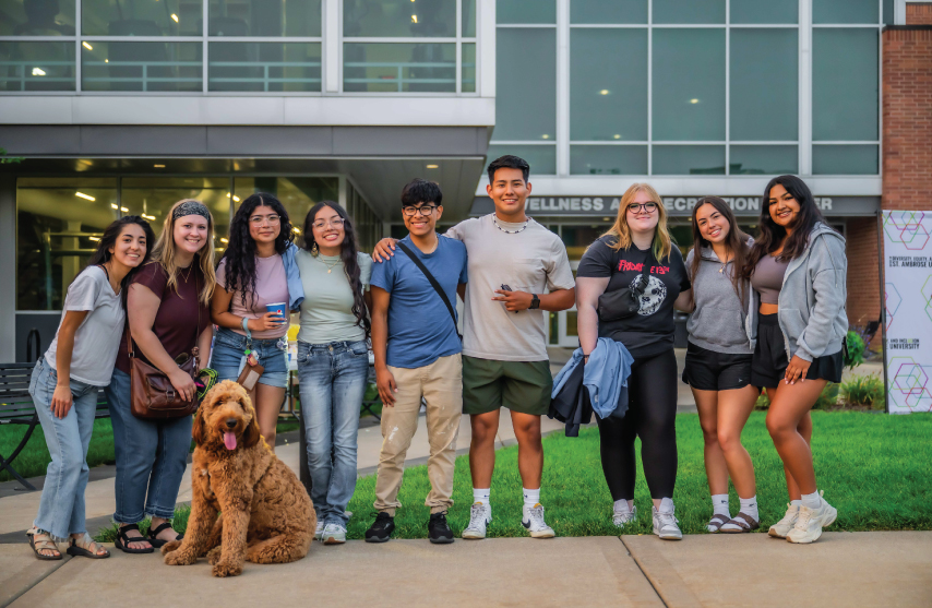 Group of students posing for a picture outside