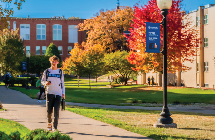 A student walking on campus in the fall