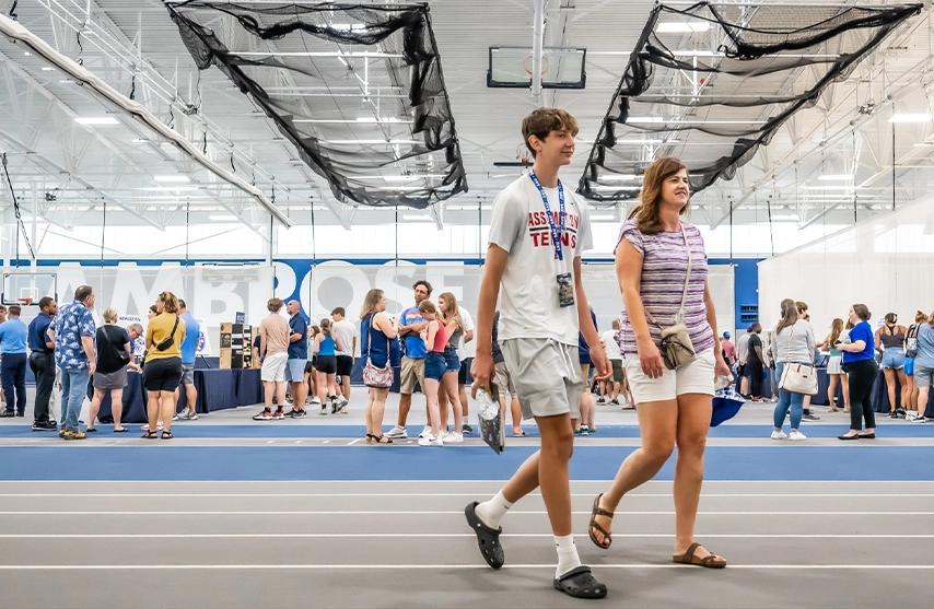 Two visitors walk inside the Wellness and Recreation center during an activity fair.