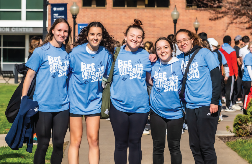 students outside participating in bee the difference day at SAU