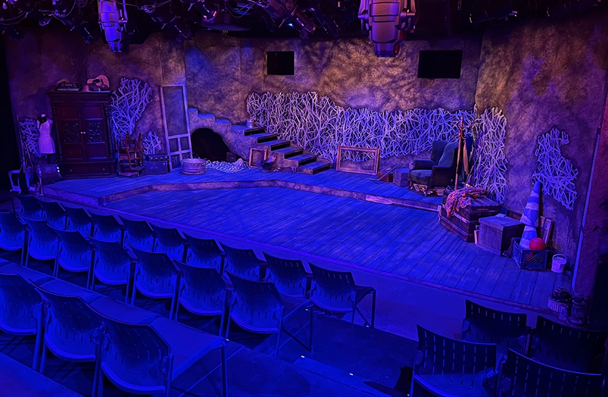 Stage made up for a show under blue and purple lights.