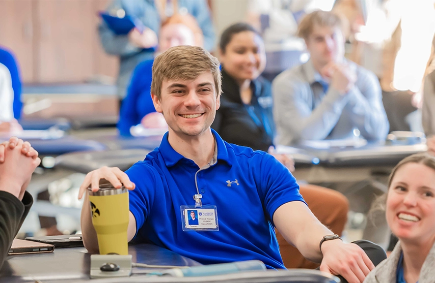 Students smile at the camera.