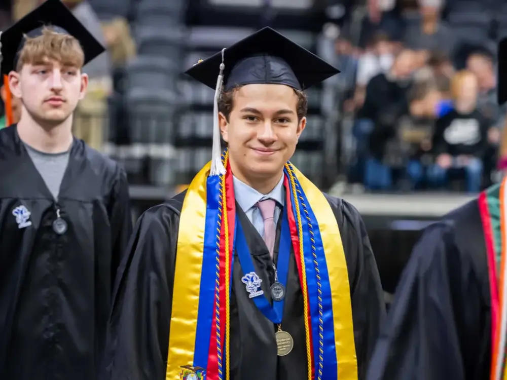 Graduate smiling at commencement ceremony