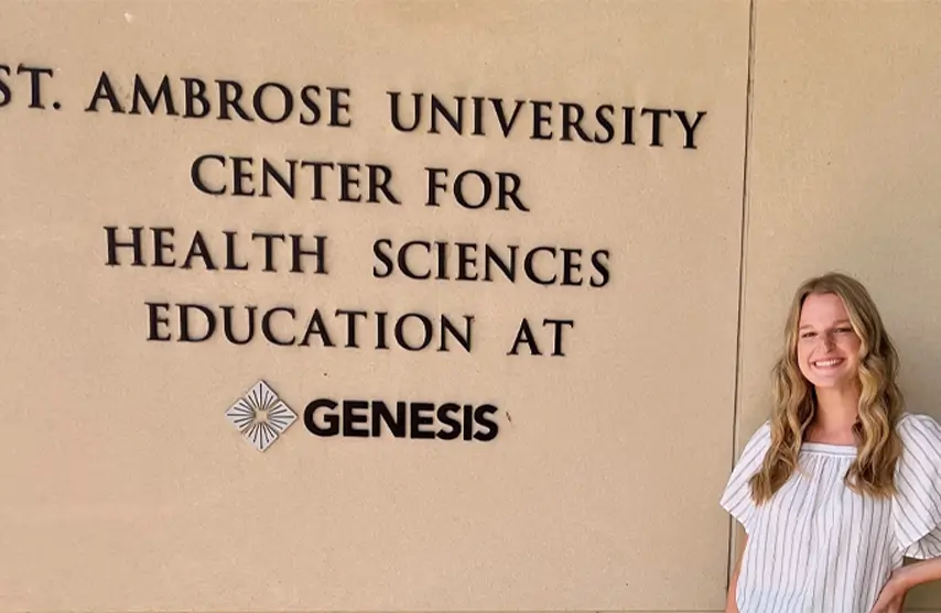 A woman standing next to a sign titled 