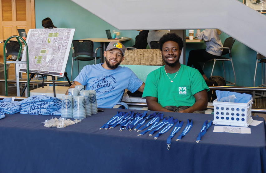 Students at table wearing first generation t-shirts.