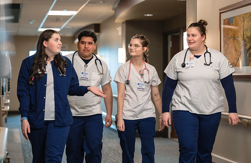 A group of nursing students walk and talk.