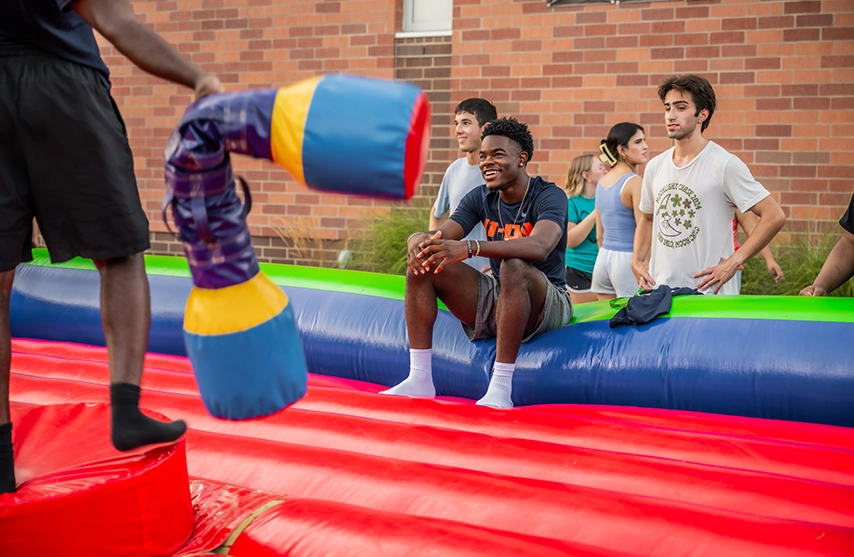 Students play on a bounce house at St. Ambrose University during a school sponsored festival.