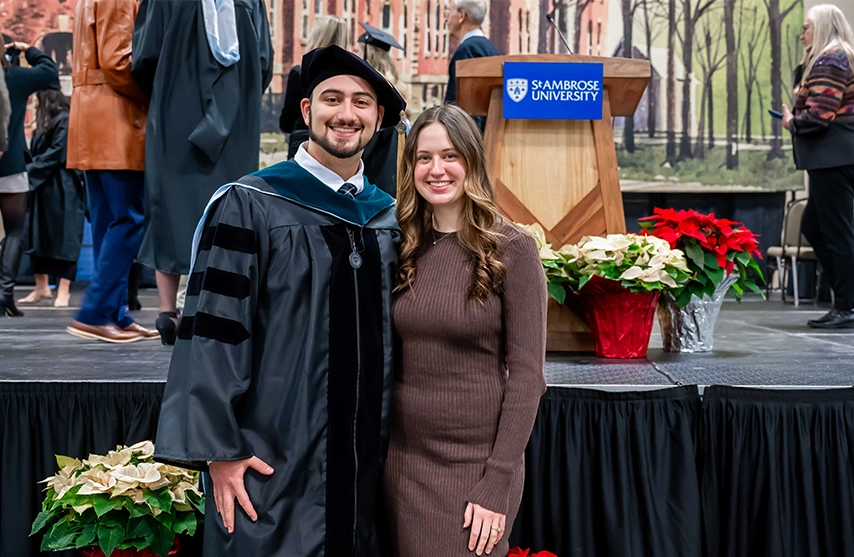 Vince Thomas ’23, DPT ’25 and Abby (Cowan) ’23 stand together at the St. Ambrose University Commencement ceremony.