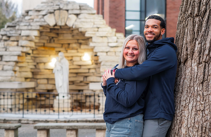 Paige (Fiscella) ‘23 and Yemi Ward ‘23, ‘26 MOL pose for a photo at The Grotto at St. Ambrose University.