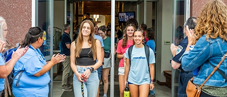 Incoming Freshmen as SAU walk out of opening mass to faculty and staff clapping for them.