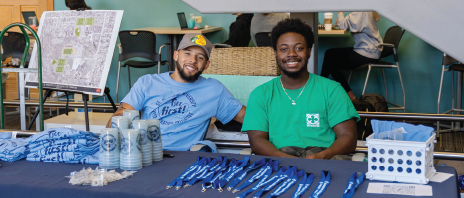 Students at table wearing first generation t-shirts.