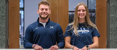 Jack Day and Norah Perkins smile at the camera.