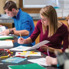 A group of students doing labwork in a biology lab.