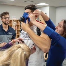 Kinesiology students conducting an assessment in a lab setting.