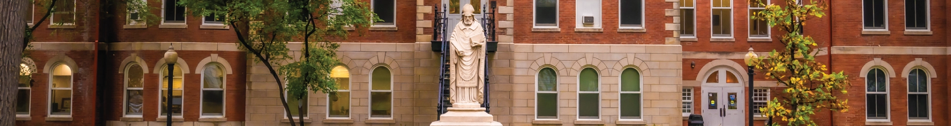 Statue of St. Ambrose outside Ambrose Hall.