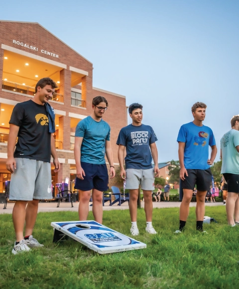 Students outdoors playing lawn games.