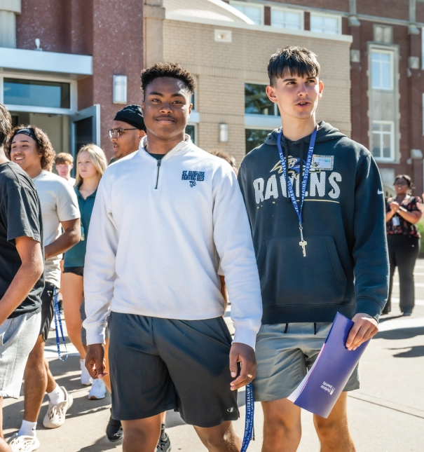 Two students exiting the chapel after an event.