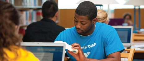 Student utilizing an Anatomy Kit at the St. Ambrose University library.