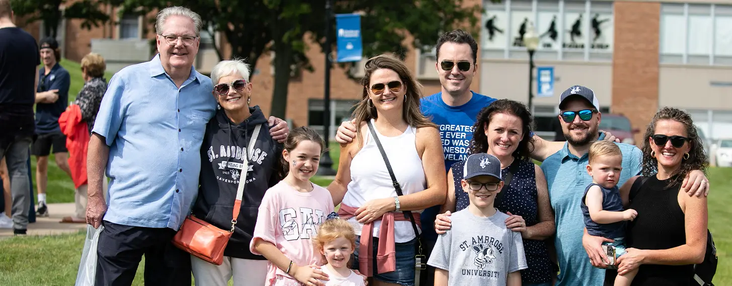 A happy family standing in front of a building, smiling.