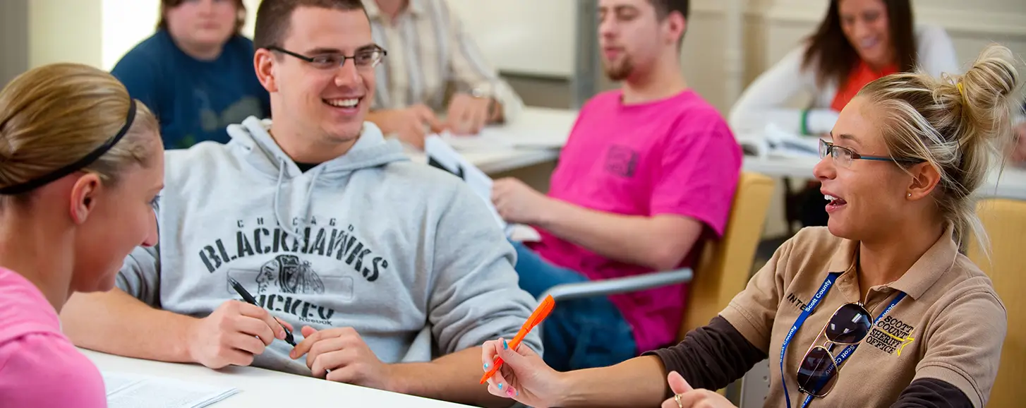 Students in a classroom discussing course materials.