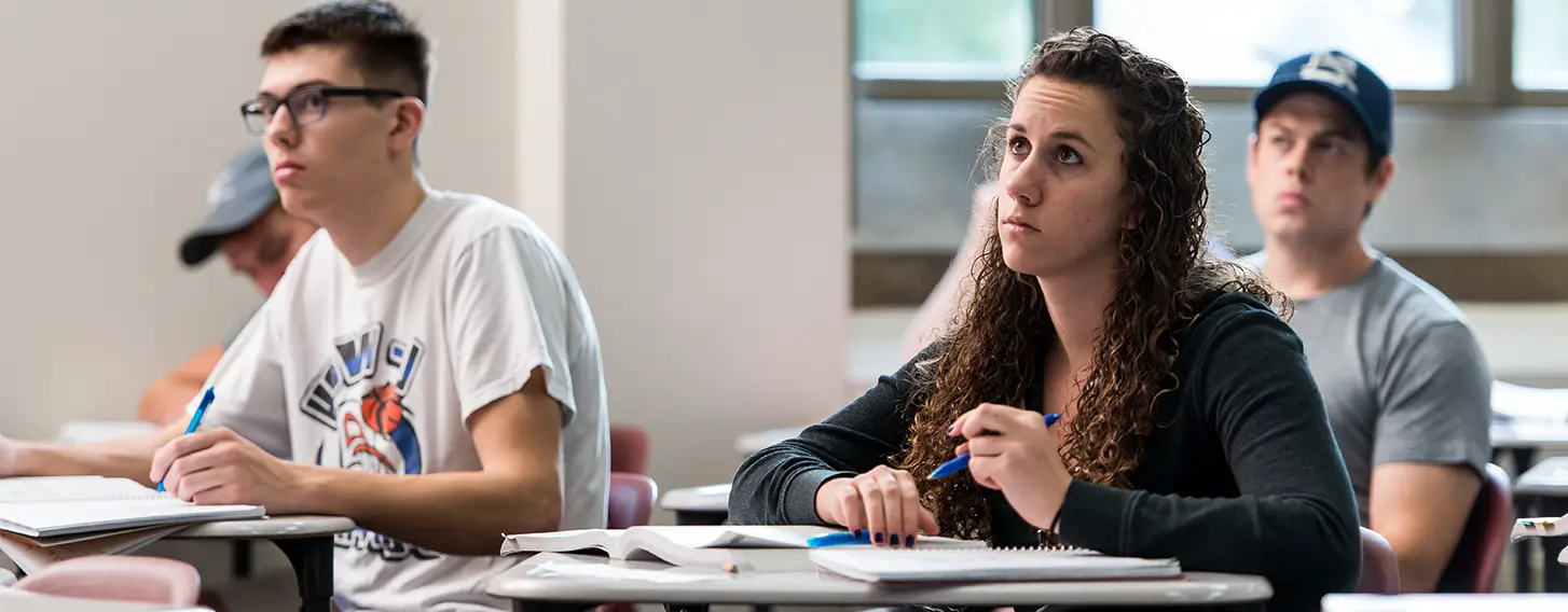 A group of students taking notes in a psychology class.