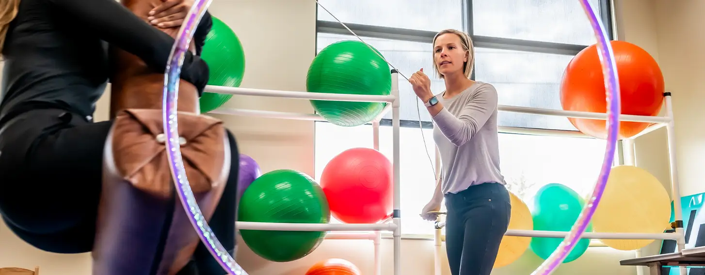 Professor leading sensory and motor skills lab in occupational therapy classroom.