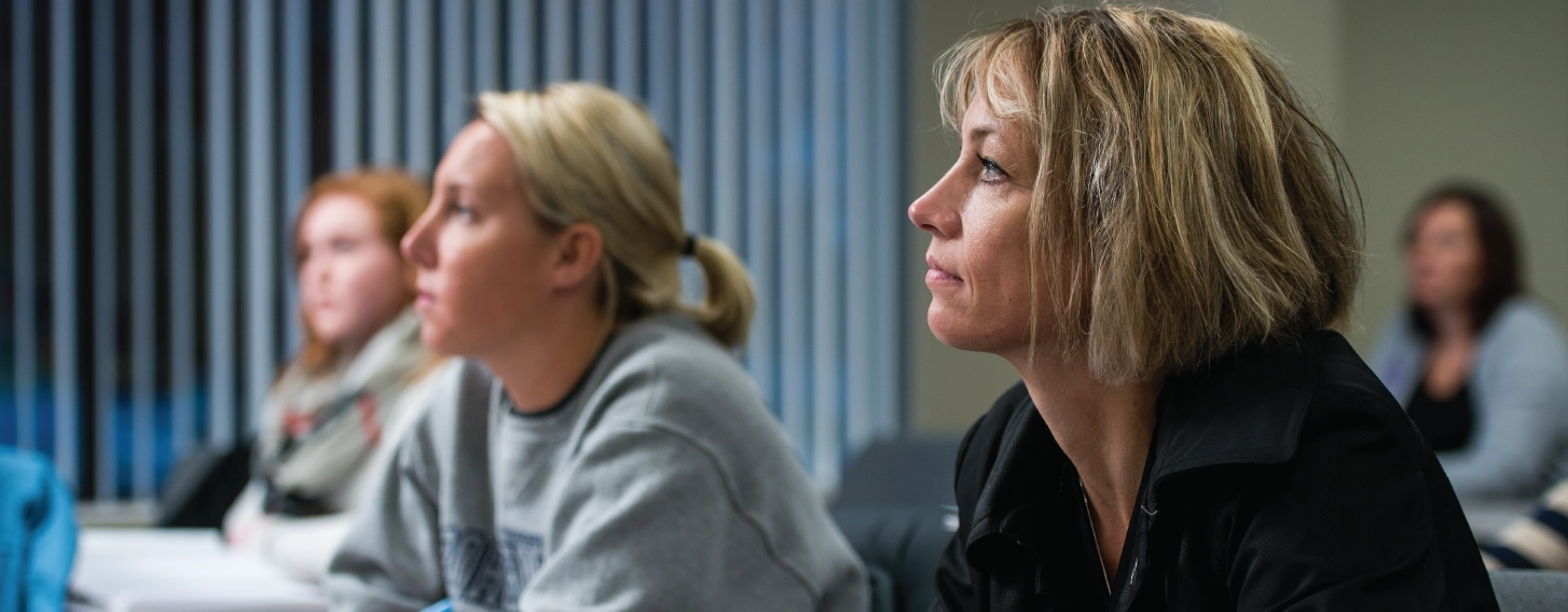 A student looking forward attentively in a classroom.