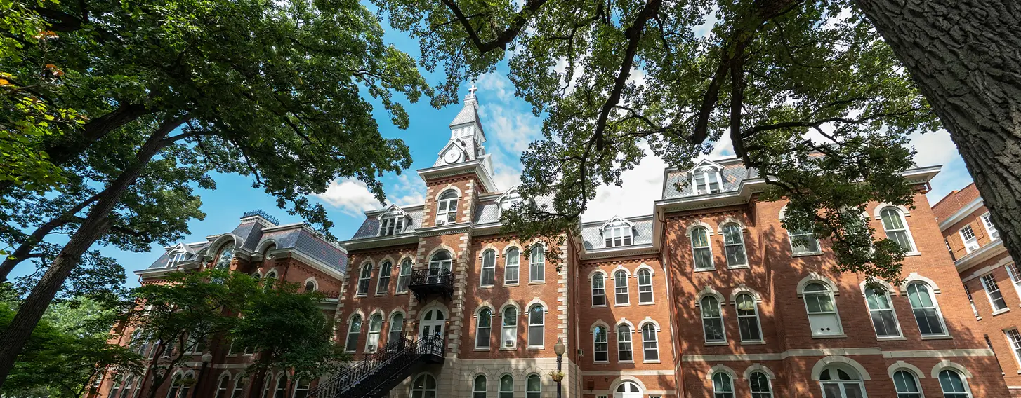 A photo of the beautiful and historic Ambrose Hall, a large brick building with a clock tower.