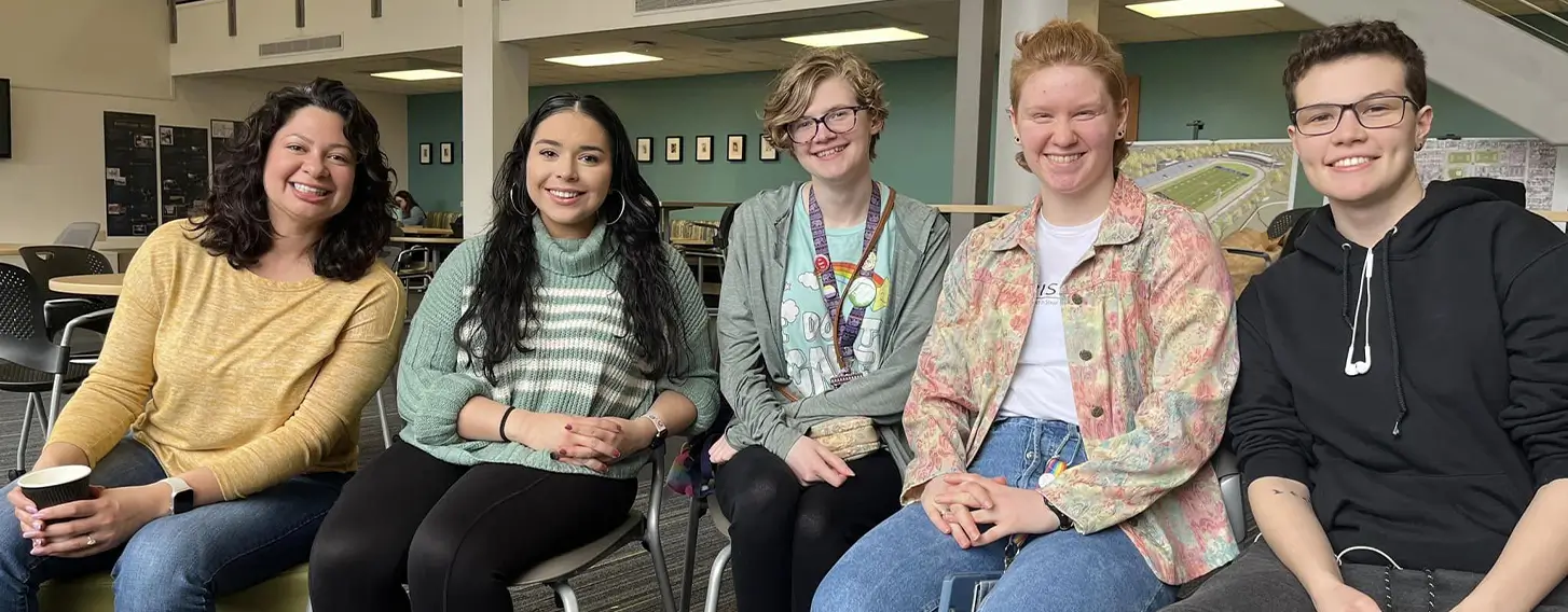 A group of students posing at an inside campus event