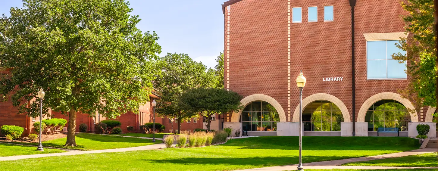 A photo of the SAU Library, a large brick building.