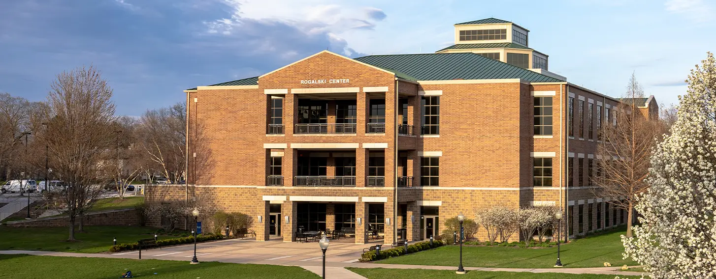 The St. Ambrose Rogalski Center featuring a tree in full bloom.