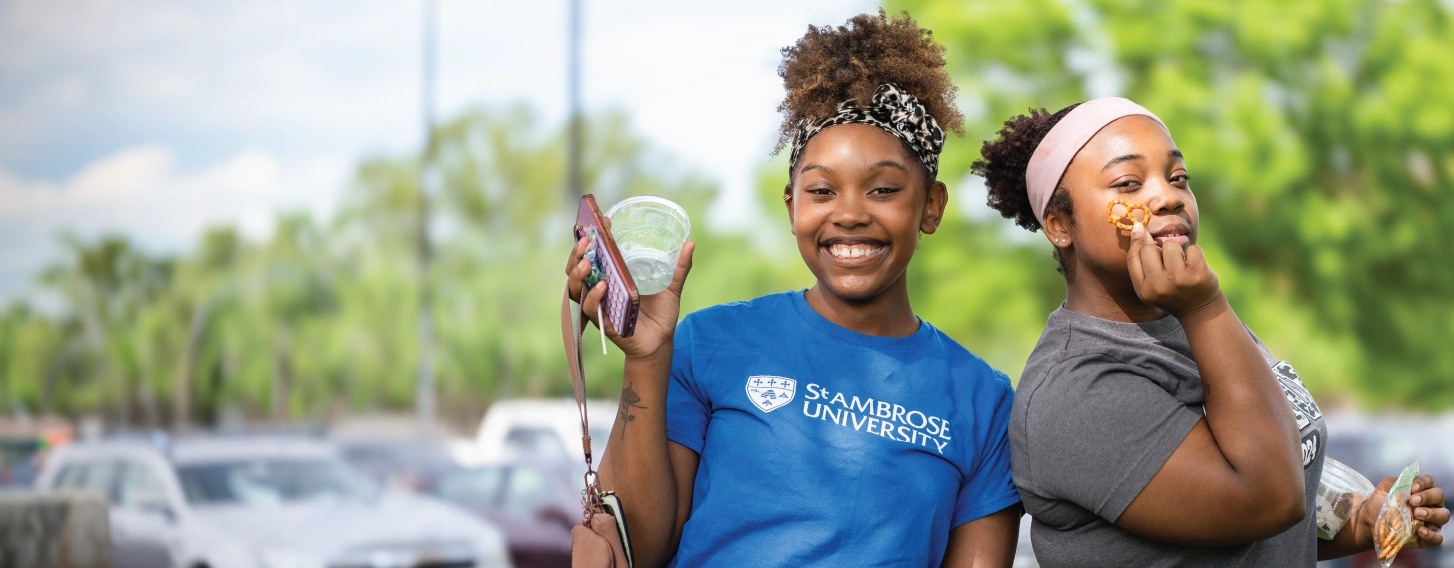 Two students posing outdoors.
