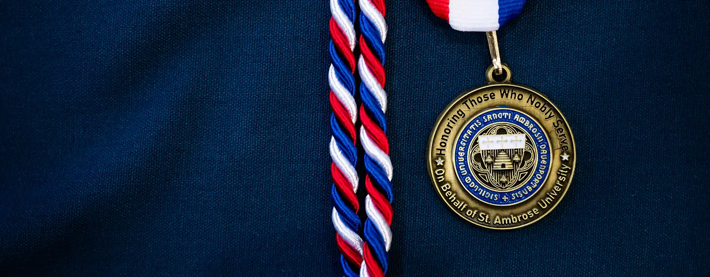 A medal and a ribbon adorning a blue shirt, symbolizing achievement and recognition for veteran service.