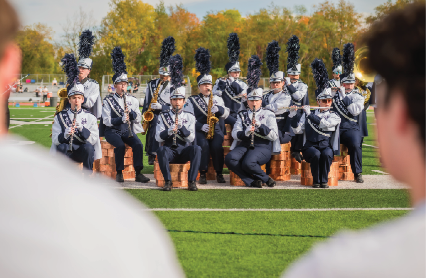 A group of the marching band in formation on the football field