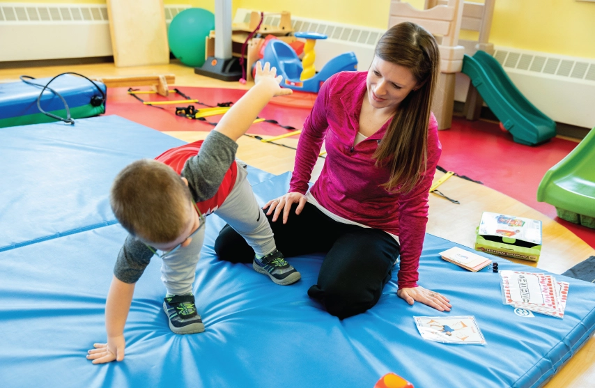 A woman interacting with a young child.