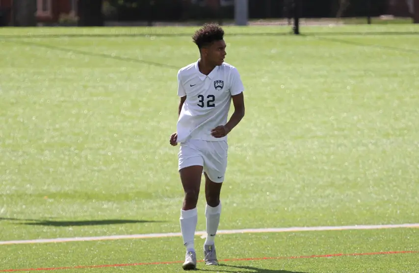 A young man playing soccer.