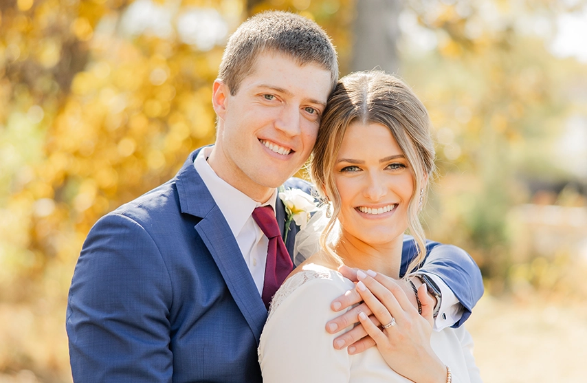 Reeann and her husband smile at the camera on their wedding day.