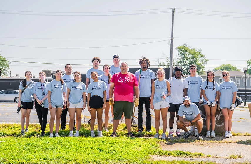 A group of first years smile at the camera after doing community service on BeeComing Ambrosian Day.