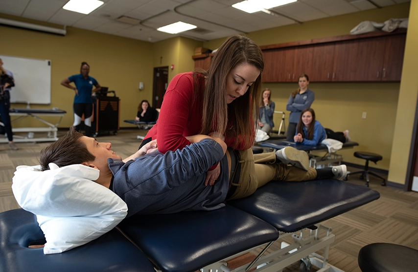 Students practice physical therapy techniques.