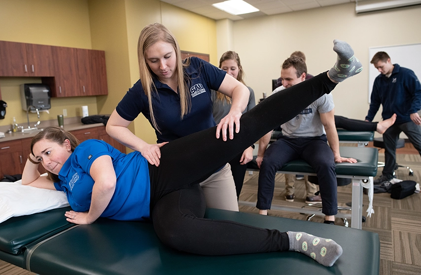Students practice physical therapy techniques.