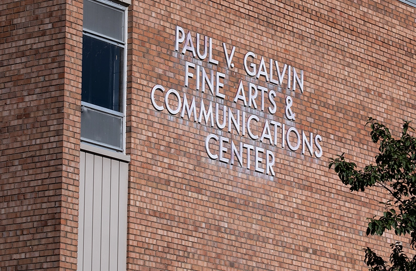 A picture of a brick building that reads Paul V. Glavin Fine Arts and Communications Center.
