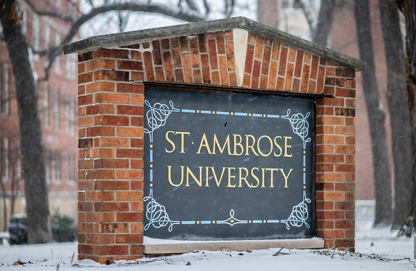 A brick sign reads St. Ambrose University.