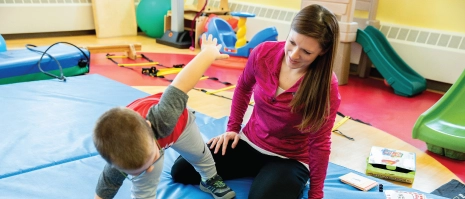 A woman interacting with a young child.