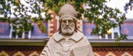 A stone statue of Saint Ambrose of Milan outside.