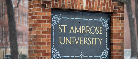 A brick sign reads St. Ambrose University.