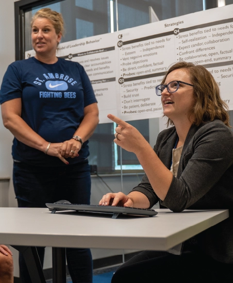 Two individuals conversing during a training course.