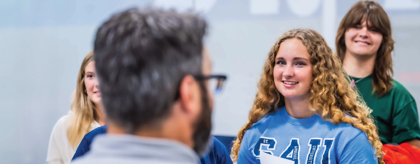 Student smiling during group activity indoors.